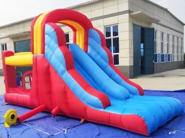 Colorful inflatable jumping castle with dual blue slides and play area, perfect for kids' events. Buy affordable, high-quality options online in South Africa.