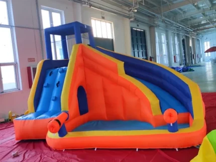 Vibrant inflatable water slide with climbing wall and splash pool, perfect for kids' events. Buy affordable, high-quality options online in South Africa.